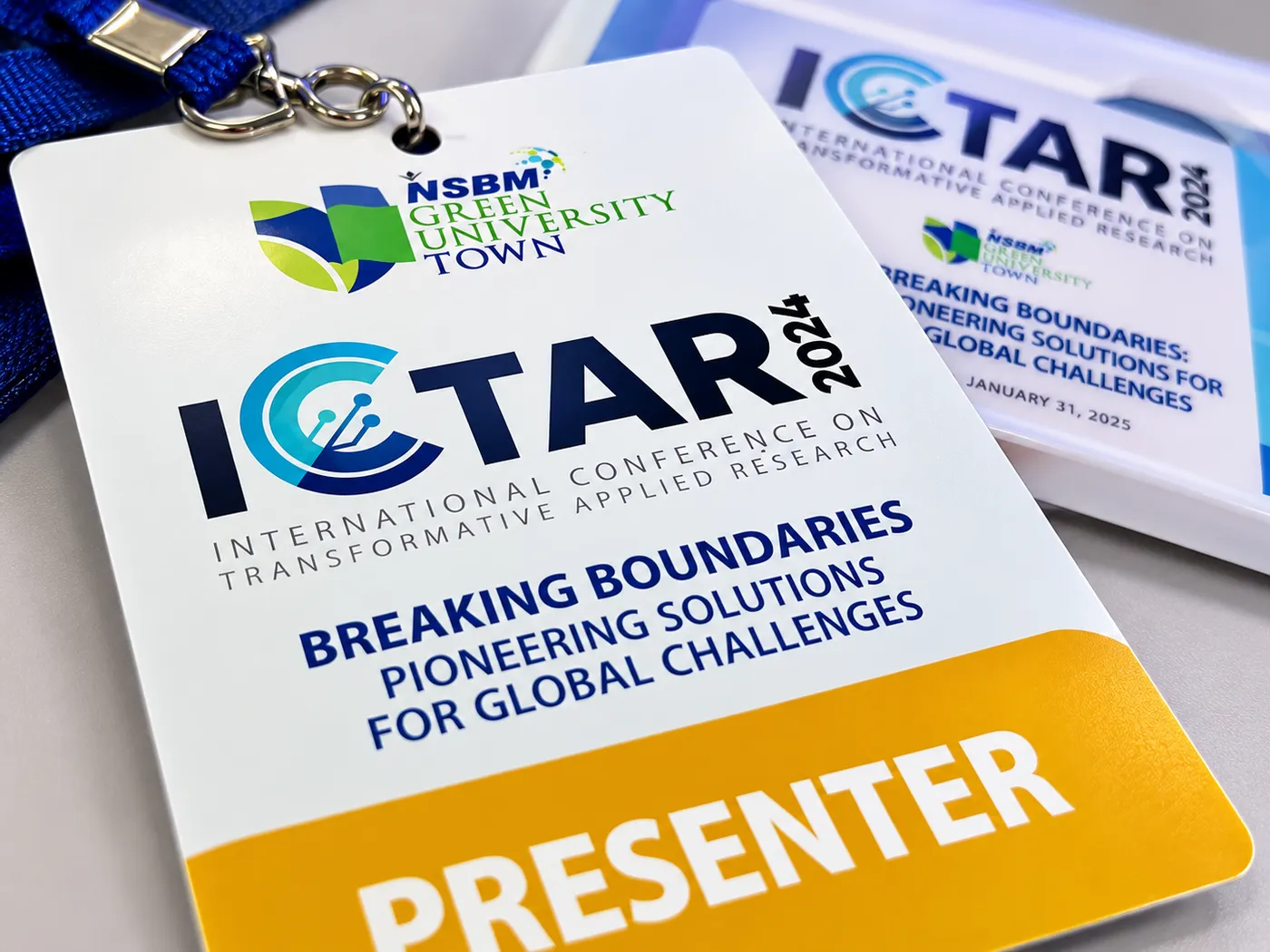 The ICTAR 2024 presenter badge on its lanyard.