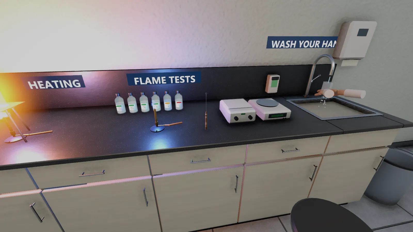 The wall bench for heating and flame tests, with hot plates, reagent bottles and the hand-washing sink.
